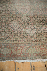 Distressed floral main border and field of a Persian Senneh rug with visible abrashes.