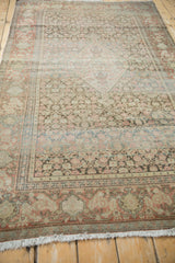 Distressed traditional Senneh rug, cochineal red floral border, and faded field.