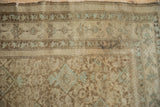 Close-up of distressed antique Malayer pile showing Herati motif in pale coffee and dusty blue.
