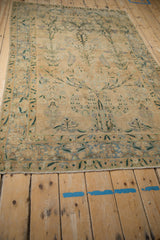 Distressed pile and unique leopard-like border shades on an antique Persian Yezd rug.