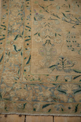 Distressed pile texture and muted floral pattern of a hand-knotted antique Yezd rug.