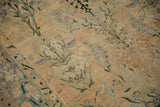 Antique Yezd rug's distressed cream field, expressively drawn blue and green floral vines, unique mottled border.