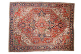 Vintage Heriz carpet, brick red field, concentric navy blue medallion with palmettes, green spandrels.