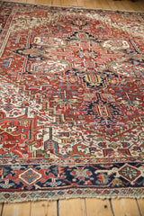 Vintage Heriz hand-knotted carpet's geometric blossoms, floral arabesques in brick red, navy.