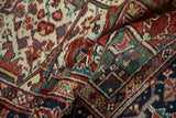 Rolled vintage Heriz rug texture, showcasing geometric patterns and polychromatic side selvage.