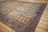 A perspective across the antique Farahan Sarouk showing the staggered floral sprays on its sand field.