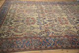 Angled view of the antique Farahan Sarouk's low pile, showing staggered floral sprays and boteh motifs.
