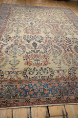 A low angle view of an antique Farahan Sarouk carpet's textured pile and reciprocating floral sprays.