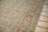Distressed vintage Tabriz carpet showing softened madder root Samovar border and Herati field.