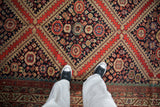 Detailed view of antique Malayer rug's vibrant gem-tone motifs, including pomegranate and boteh designs.