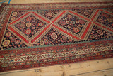 Antique Malayer carpet showcasing intricate tomato red borders and gem-tone boteh motifs.