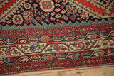 Antique Malayer carpet border with intricate geometric motifs in vivid gem-like red, navy, green.