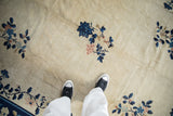 Low pile showing knot heads and floral sprays in cobalt blue and blush on a beige field.