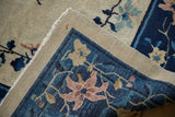 Corner of an antique Peking rug showing the sand-colored pile and the detailed weave on the reverse.