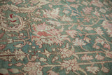 Distressed Karaja carpet with jade green field, terracotta floral motifs, and visible abrash.
