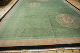 Art Deco carpet border with dusty mint green, beige, and navy stripes, showing fringe.