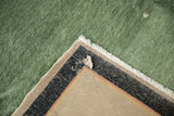 Antique Nichols Art Deco carpet foundation, white fringe, and worn selvage against green pile.