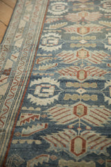 Worn-to-the-knot texture on the dusty blue field and ivory border of a Malayer runner.