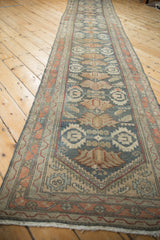 Full length perspective of the distressed vintage Malayer runner's repeating geometric pattern.
