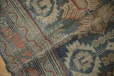 Close-up view of the vintage Malayer rug's low, worn pile and hand-knotted texture.
