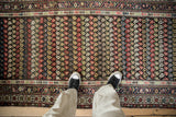 Overhead view of a vintage Kurdish Hamadan runner's colorful boteh pattern and hand-knotted texture.