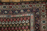 Detailed corner of a Kurdish Hamadan runner showing boteh field and multi-colored geometric borders.