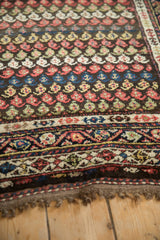 Textured pile of a vintage Kurdish Hamadan runner with colorful, staggered boteh motifs and a detailed border.