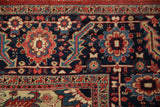 Serrated leaf and floral motifs in cherry red and sapphire blue on a vintage Persian Heriz.