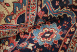 Angled view of the short, hand-knotted pile and floral motifs on a vintage Heriz carpet.