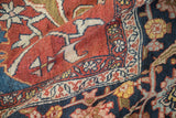Textured low pile and bold floral arabesques on the corner of an antique Heriz carpet.