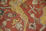 Detailed view of the mostly even wear across the knot heads of a hand-knotted antique Heriz carpet.