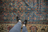Antique Bakshaish rug: sapphire blue Herati pattern with cochineal red, flowing into ivory main border.