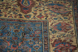 Rich sapphire blue border and antique ivory Herati pattern on this Persian Bakshaish carpet.