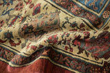 Folded texture of antique Bakshaish carpet, showing ivory Herati pattern and sapphire border.