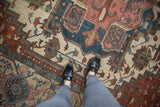Antique Karaja carpet displaying geometric stepped patterns in pale red, dusty blue, and beige.