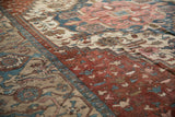 Storied geometric border and field patterns of an antique Karaja carpet in copper, dusty teal, and beige.