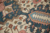 Antique Karaja rug detail with angular blossoms and geometric stepped design in navy and rose tones.