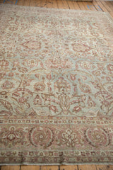 Detail of vintage distressed Yezd rug showing powder blue field, blush palmettes, and worn texture.
