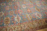 Antique Bakshaish carpet's repeating serrated guls, floral blossoms on aquatic blue field and patterned border.