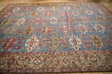 Antique Bakshaish carpet detail: aquatic blue field, pale red serrated guls, geometric border.