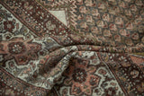 Folded vintage Kurdish Hamadan rug revealing distressed pile and intricate rustic floral patterns.