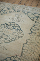Distressed Doroksh rug corner spandrel, showing wear to knot heads, dusty teal vines.