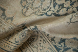 Distressed antique Doroksh rug, worn pile reveals foundation, with ivory and dusty teal vines.