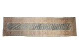 Distressed vintage Malayer runner with an abrashed blue field showing repeating plant motifs and complex sandalwood borders.