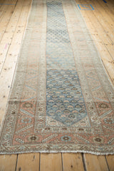 Long perspective view of a distressed Malayer runner, highlighting the abrashed blue field and sandalwood borders.