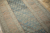Softly worn texture and abrashed field of a Malayer rug in dusty blue and sandalwood.