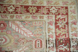 Corner detail of a distressed Persian Karaja rug's starburst checkered vine main border.
