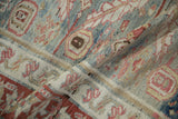 The flexible hand-knotted weave and textured pile of a distressed antique Karaja carpet.