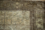 Vintage distressed Hamadan rug corner with faded beige field and brown Herati style border.