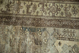 Detail of a vintage distressed Hamadan rug with discoloration and exposed knot heads.